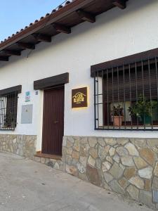 a building with a sign on the side of it at Casa El saucar in El Robledo