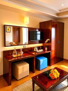 a living room with a table and a television at MiRAGE PYRAMiDS HOTEL in Cairo