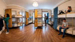 a group of people in a room with bunk beds at The Friends Hostel & Sauna in Kutaisi +33 photos