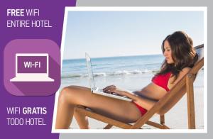 a woman sitting in a chair on the beach with a laptop at FIESTA DEL CARIBE - LOS CORALES beach in Punta Cana +52 photos