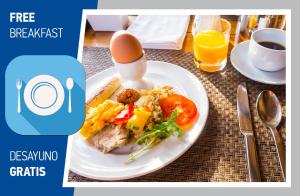 a plate of food with an egg on a table at FIESTA DEL CARIBE - LOS CORALES beach in Punta Cana