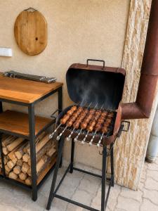 a grill with a bunch of hot dogs on it at The Friends Hostel & Sauna in Kutaisi