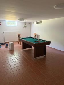 a room with a pool table and two chairs at Omran House in Ystad +6 photos