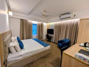 a hotel room with a bed and a desk at Laurel Lakefront Hotel in Dhaka +37 photos