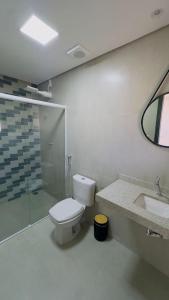 a bathroom with a toilet and a shower and a sink at Villa Jasmin Blanc GuestHouse in Tiradentes