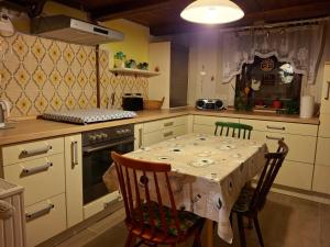 a kitchen with a table and chairs and a stove at Haus Semmelrodt in Witzenhausen