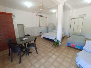 a room with two beds and a table and a bed at Casa jardin 2 in Jardín América