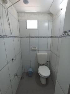 a small bathroom with a toilet and a window at Casa jardin 2 in Jardín América
