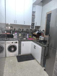 a kitchen with a dishwasher and a washer at Sara guest house in Agadir