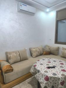 a living room with a couch and a table at Sara guest house in Agadir