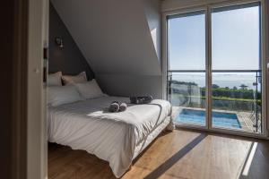 a bedroom with a bed and a large window at residence kersailliou in Roscoff +30 photos