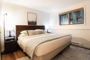 a bedroom with a large bed and a window at Mt Baker Den, Sleeps 4 in Glacier