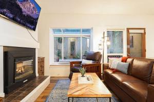 a living room with a couch and a fireplace at Mt Baker Den, Sleeps 4 in Glacier
