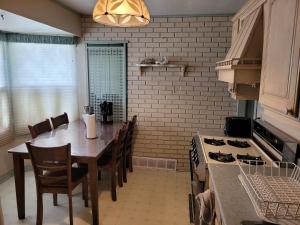 a kitchen with a table and chairs and a stove at Sleiman's Guest House in Windsor