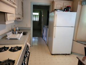a kitchen with a white refrigerator and a stove at Sleiman's Guest House in Windsor