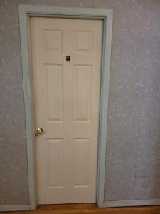 a white door in a room with a purple wall at Sleiman's Guest House in Windsor