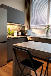 a kitchen with a table and a counter top at Apartman Deluxe Astrova B in Bratislava +10 photos