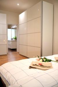 a bedroom with a large white bed with flowers on it at Apartman Deluxe Astrova B in Bratislava