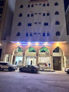 a car parked in front of a building at Johraat Taba Tourist Hostel in Medina +1 photo