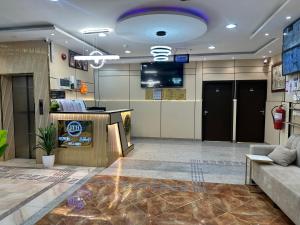 a lobby with a waiting room with a tv on the wall at Johraat Taba Tourist Hostel in Medina