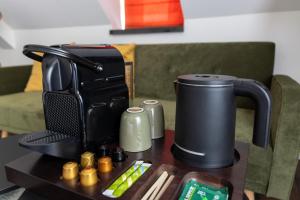 a coffee maker sitting on top of a table at Hotel Hof van Gelre by Flow in Lochem