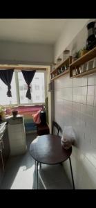 a small kitchen with a table and a table and a window at Tanger in Tangier