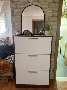 a dresser with a mirror on top of it at Tanger in Tangier