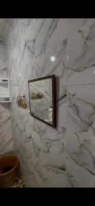 a bathroom with a mirror on a marble wall at Tanger in Tangier