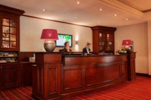 two people standing at a bar in a room at Hotel Hof van Gelre by Flow in Lochem