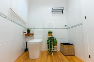 a bathroom with a toilet and plants in it at LAR DE SEFA in Redondela +21 photos