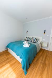 a bedroom with a bed with a blue blanket at LAR DE SEFA in Redondela