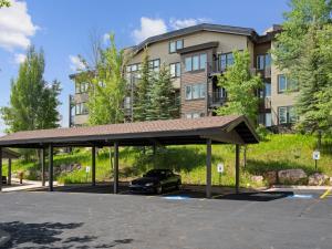 a car parked in a parking lot in front of a building at Crestview Condominiums by All Seasons Resort Lodging in Park City