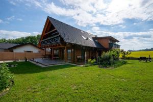 a large wooden house with a large yard at Zrub Kriváň Chalet with Mountain View in Závažná Poruba