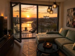 a living room with a couch and a large window at New Eurovea Tower in Bratislava