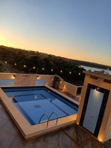 a swimming pool on the roof of a building at Hotel Diromani in Hernandarias +18 photos