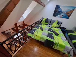 a bedroom with a bed with a green comforter at GR ooms-Rents in Gemmrigheim