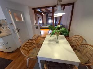 a dining room with a white table and chairs at GR ooms-Rents in Gemmrigheim