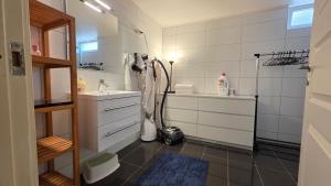 a bathroom with a sink and a hair dryer at Gjestehus i Tveit in Kristiansand +9 photos