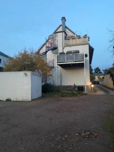 a white building with a balcony on the side of it at Lichtblick in Radebeul +4 photos