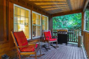 a porch with two chairs and a stove at Twin Lakes Cabin in Glacier