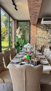 a dining room with a table with wine glasses at Villa Ikalto in Telavi