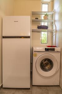 a refrigerator and a washing machine in a kitchen at Studio74 in Patra