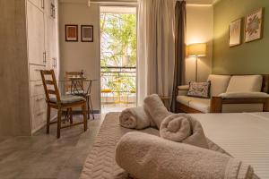 a bedroom with a bed with a pile of towels at Studio74 in Patra