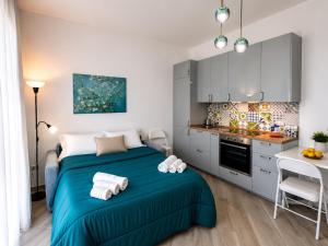 a small bedroom with a bed and a kitchen at Sul Mare Apartment - Seafront with Sea View in Salerno