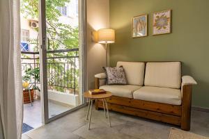 a living room with a couch and a table at Studio74 in Patra