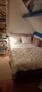 a bedroom with a bed and a book shelf at Homestay Maashees in Maashees