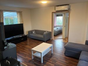 a living room with a couch and a table at Villa in Kvidinge