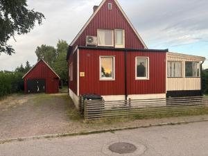 a red house with a red roof at Villa in Kvidinge