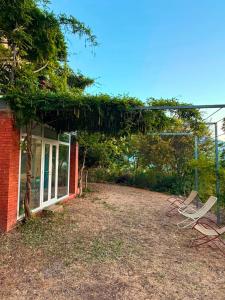a group of chairs sitting in a yard next to a house at La Manna di Zabbra in Pollina +22 photos
