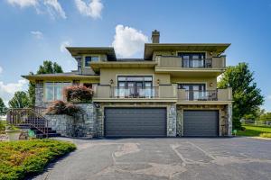 a large yellow house with two garage doors at Private Getaway! Massive Springfield Area Home in Rogersville